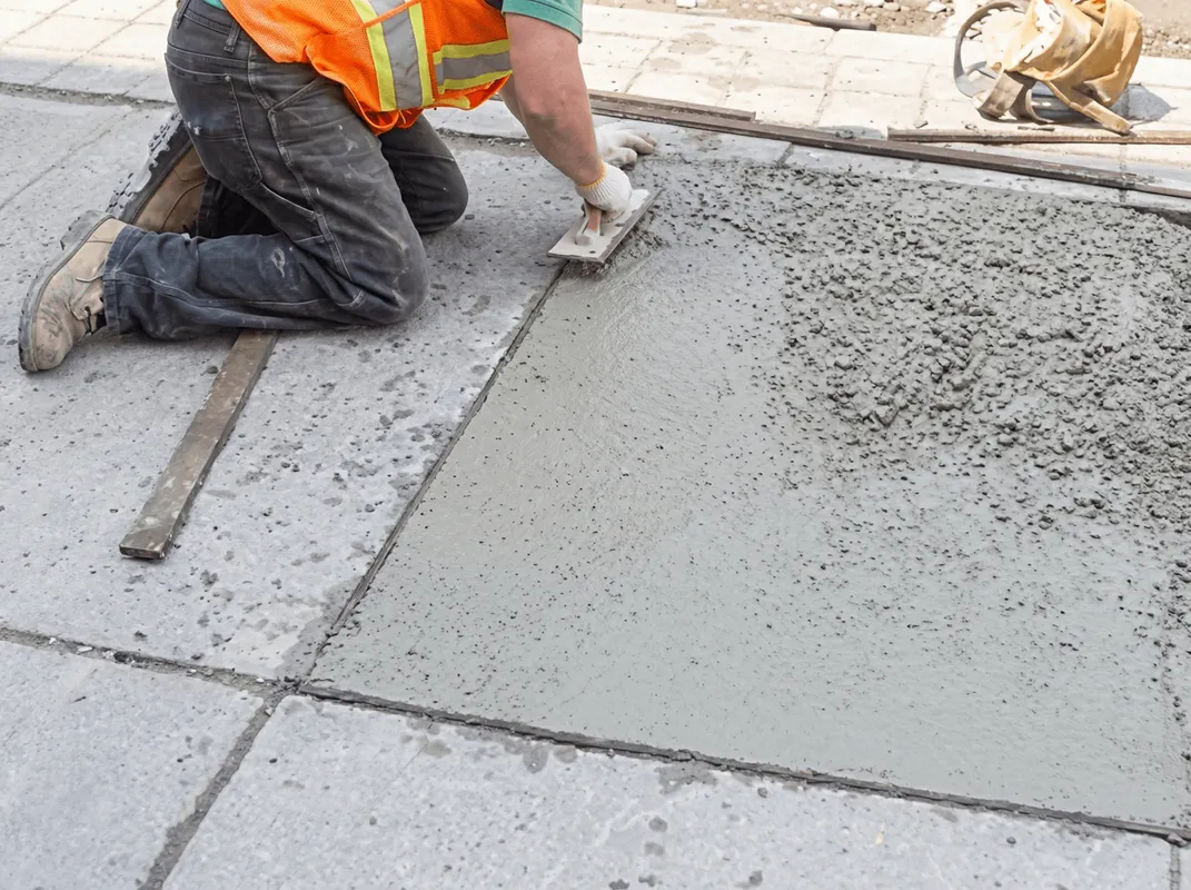 Professional repairing a concrete floor in Staten Island, NY